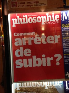 You've gotta love a country where the news kiosk by the taxi stop advertises a philosophy magazine, right?  "Subir" has a bunch meanings related to suffering (probably the intended sense in a philosophy magazine), putting up with, dealing with, undergoing, and enduring.
